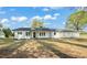 Charming white ranch home with black trim and a well-manicured lawn offers simple elegance at 8917 Fowler Rd, Zebulon, NC 27597