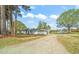 Scenic long view of the charming white ranch home with detached garage on a large lot at 8917 Fowler Rd, Zebulon, NC 27597