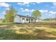 Side view of a beautifully renovated ranch home with a well-maintained lawn at 8917 Fowler Rd, Zebulon, NC 27597