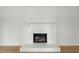 Close up of the fireplace featuring painted white brick at 8917 Fowler Rd, Zebulon, NC 27597