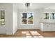 Bright eat-in kitchen featuring white cabinets, new flooring and large windows at 8917 Fowler Rd, Zebulon, NC 27597