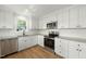 Bright kitchen featuring modern appliances, granite countertops, and stainless steel sink at 8917 Fowler Rd, Zebulon, NC 27597