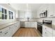 Bright kitchen with stainless appliances, granite counters, and white cabinets at 8917 Fowler Rd, Zebulon, NC 27597
