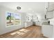 Eat-in kitchen featuring white cabinets, stainless appliances, and a large window at 8917 Fowler Rd, Zebulon, NC 27597