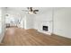 Bright, open living room with white brick fireplace and new flooring at 8917 Fowler Rd, Zebulon, NC 27597
