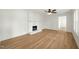 Bright open living room with new flooring and brick fireplace at 8917 Fowler Rd, Zebulon, NC 27597