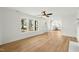 Bright living room with new flooring, brick fireplace, and view of the kitchen at 8917 Fowler Rd, Zebulon, NC 27597