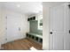 Well-lit mudroom featuring a bench, coat hooks, and ample storage space for organization at 8917 Fowler Rd, Zebulon, NC 27597