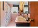 Retro bathroom featuring a pink tile motif, double sink, and flower-patterned shower curtain at 906 Perry Rd, Zebulon, NC 27597