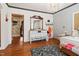 Bathroom with wood floors featuring a chandelier and ample vanity space at 906 Perry Rd, Zebulon, NC 27597