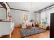 Spacious bathroom with a freestanding tub, hardwood floors, and decorative chandelier at 906 Perry Rd, Zebulon, NC 27597