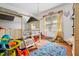 bedroom features a playful loft bed, hardwood floors, and bright natural light at 906 Perry Rd, Zebulon, NC 27597