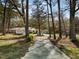 Driveway leading to a home with mature trees providing ample shade at 906 Perry Rd, Zebulon, NC 27597