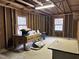 A garage with exposed wood rafters and shelving along the walls at 906 Perry Rd, Zebulon, NC 27597