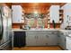 View of the kitchen with stainless steel refrigerator, traditional cabinets, window, and decorative elements at 906 Perry Rd, Zebulon, NC 27597