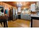 The updated kitchen features modern stainless steel appliances, lots of cabinet space, and a wood paneled ceiling at 906 Perry Rd, Zebulon, NC 27597