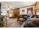 Cozy living room with a fireplace, comfortable sofas, and a ceiling fan for relaxing comfort at 906 Perry Rd, Zebulon, NC 27597