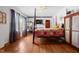Bright main bedroom with hardwood floors, 4 poster bed, and neutral walls at 906 Perry Rd, Zebulon, NC 27597