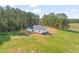 Aerial view showcases a modern home surrounded by lush greenery and vast open spaces at 9550 Stallings Road Rd, Spring Hope, NC 27882