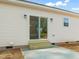 A backyard patio with sliding glass doors offers a seamless transition from indoor to outdoor living at 9550 Stallings Road Rd, Spring Hope, NC 27882