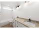 Bathroom showcasing double sinks, granite counters, modern lighting, and a tub at 9550 Stallings Road Rd, Spring Hope, NC 27882