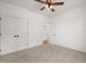Carpeted bedroom with a large closet and a doorway showing hardwood flooring in the adjacent room at 9550 Stallings Road Rd, Spring Hope, NC 27882