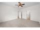 Spacious bedroom with plush carpet, ceiling fan, and multiple entryways at 9550 Stallings Road Rd, Spring Hope, NC 27882