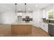 Spacious kitchen featuring granite countertops, stainless steel appliances, and wooden flooring at 9550 Stallings Road Rd, Spring Hope, NC 27882