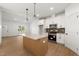 Stylish kitchen with stainless appliances, granite counters, a center island and wood flooring at 9550 Stallings Road Rd, Spring Hope, NC 27882