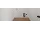 Bright laundry room with white walls, hardwood floors, and convenient hookups for washer and dryer at 9550 Stallings Road Rd, Spring Hope, NC 27882