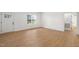 Bright living room featuring light wood flooring, a window and white trim throughout at 9550 Stallings Road Rd, Spring Hope, NC 27882