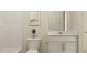 Bright bathroom features a white vanity, toilet, and tub/shower combination at 1002 Sora Way, Durham, NC 27703