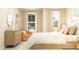 Bright bedroom with an orange accent chair, light-colored dresser, and large windows for natural light at 1011 Red Roses Ave, Durham, NC 27703