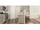 Modern kitchen with stainless appliances, gray cabinets, and counter seating at 1011 Red Roses Ave, Durham, NC 27703