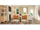Bright living room with fireplace, hardwood floors, and natural light from large windows at 1011 Red Roses Ave, Durham, NC 27703