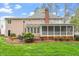 Spacious backyard featuring a large screened porch, wooden deck, and well-maintained lawn at 105 Fifemoor Ct, Cary, NC 27518