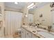 Bathroom features double sinks with granite countertops and decorative mirrors at 105 Fifemoor Ct, Cary, NC 27518