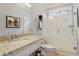 Bathroom featuring granite countertop, glass shower with subway tile surround, and natural light at 105 Fifemoor Ct, Cary, NC 27518