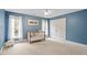 This bedroom features a blue walls, a crib, and natural light from two windows at 105 Fifemoor Ct, Cary, NC 27518