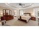 Spacious bedroom with tray ceilings, ensuite bath, and plush carpeting at 105 Fifemoor Ct, Cary, NC 27518