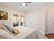 Bedroom with hardwood floors, neutral colors, and access to a screened-in porch at 105 Fifemoor Ct, Cary, NC 27518