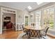 Eat-in breakfast area with hardwood flooring and abundant natural light from the surrounding windows at 105 Fifemoor Ct, Cary, NC 27518