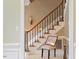 Foyer boasts tile flooring, carpeted staircase, chair rail, and decorative lighting at 105 Fifemoor Ct, Cary, NC 27518
