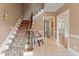 Bright foyer features tile flooring, staircase with patterned carpet, and views into adjoining rooms at 105 Fifemoor Ct, Cary, NC 27518
