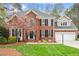 Beautiful two-story brick home with a well-manicured lawn and charming landscaping at 105 Fifemoor Ct, Cary, NC 27518