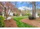 Beautifully landscaped front yard featuring a lush lawn, flowering trees, and charming walking path at 105 Fifemoor Ct, Cary, NC 27518