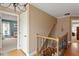 Upstairs hallway displaying hardwood floors, staircase, and access to multiple rooms at 105 Fifemoor Ct, Cary, NC 27518