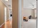 Hallway with a view to a cozy carpeted sitting room with an upholstered chair at 105 Fifemoor Ct, Cary, NC 27518