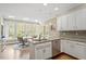 Kitchen with stainless appliances, granite countertops, and windows overlooking the backyard at 105 Fifemoor Ct, Cary, NC 27518
