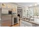 Elegant kitchen with granite countertops, stainless steel appliances, and wine storage at 105 Fifemoor Ct, Cary, NC 27518